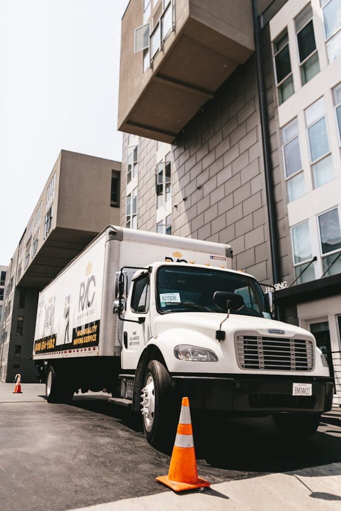 A white truck parked in front of a building